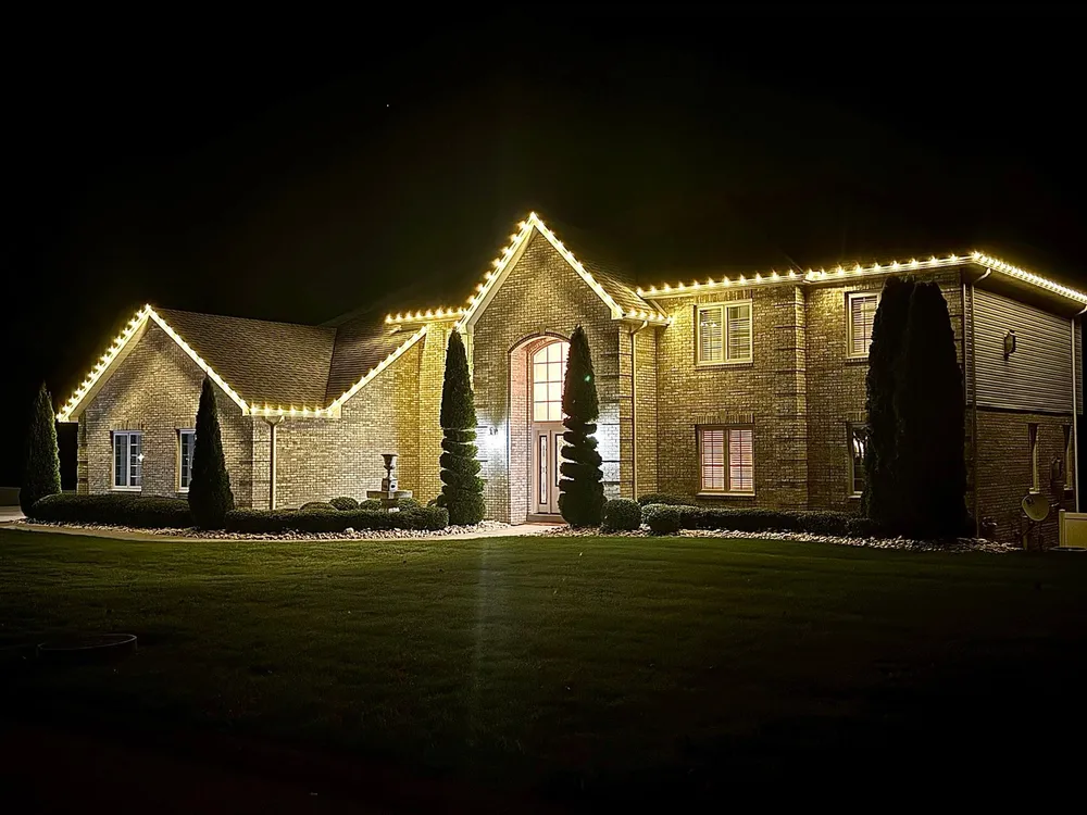 A Laurel Highlands Lighting roofline installation glowing after dark